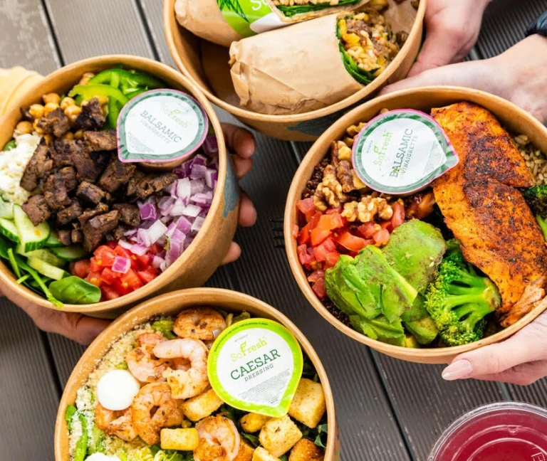 A spread of SoFresh warm bowls with proteins and fresh vegetables